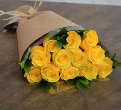 12 yellow roses with greens and filler  Hand tied with green and filler 
