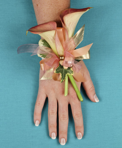 This classic prom wrist corsage of white baby roses and white ribbon