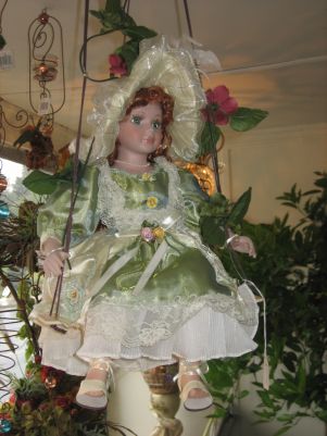 porcelain doll on swing