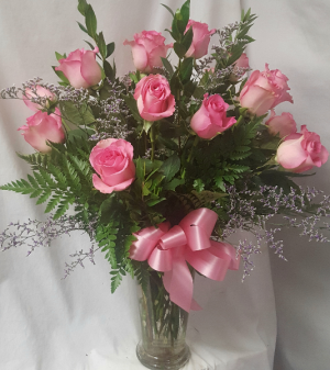 18 PINK LONG STEM ROSES arranged in a vase with  limonium if in season or baby's breath.