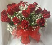 18 RED LONG STEM ROSES arranged in a vase with  filler to take home after services. 