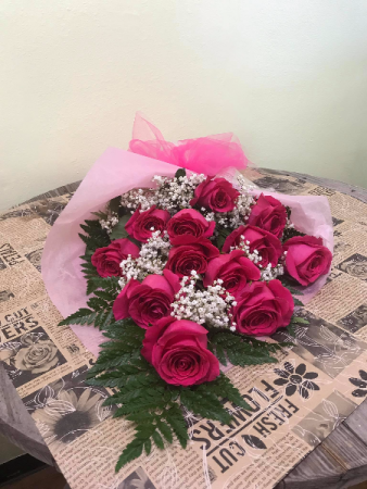 A Dozen Pink Roses Wrapped in Tissue 