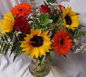 "A Fall Favorite" seasonal flowers roses,  Sunflowers, gerbera daisies with filler arranged