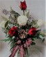 3 WHITE ROSES AND 3 RED ROSES (H)  arranged IN A CUBE VASE WITH CHRISTMAS GREENS, CHRISTMAS BOW AND PINECONE.