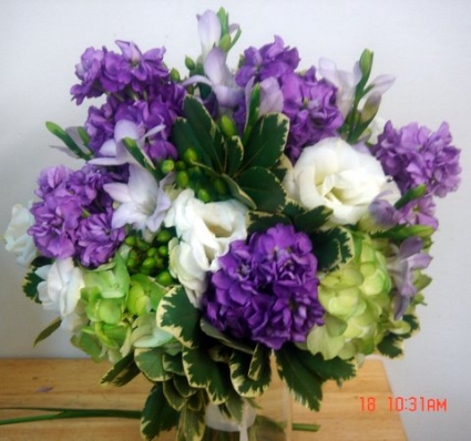 Purple, white and greens fresh flowers in a vase