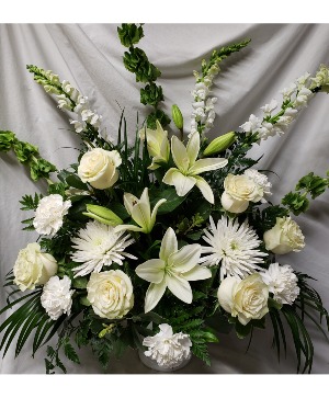 All white flowers arranged. One sided arrangement. Flowers may vary depending on stock and time frame when ordering but they will be all white