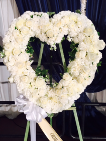 All white open heart wreath with roses & carnation 