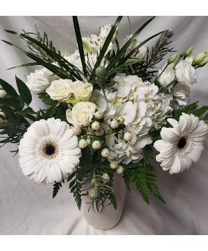 All white seasonal flowers in a vase to take home after the services. (Flowers may vary depending on seasonal and/ or availability 