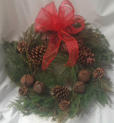 Artificial (Looks Real!) mixed Greens,pine cones, rustic bells with bow. Would be a great gift for a door or centerpiece with a candle or lantern in center.
