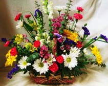 EUROPEAN GARDEN TRIBUTE Seasonal mixed bright flowers in wicker basket