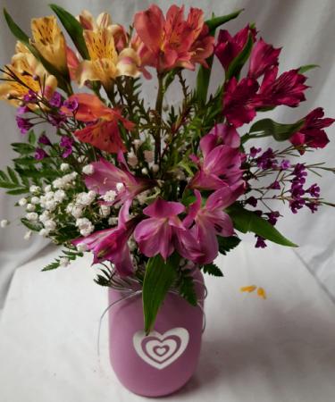 HAPPY BUDS BOUQUET...Alstroemeria Lilies Arranged with seasonal filler in a colored mason jar with a silver heart. (Mason jars may be  different color)