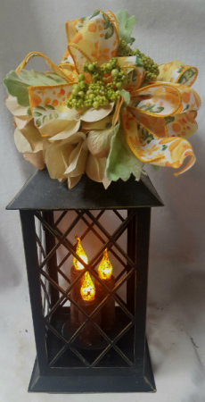 Rustic looking Tin lantern with LED lights Batteries included with seasonal silk flowers and bow(silk may vary)