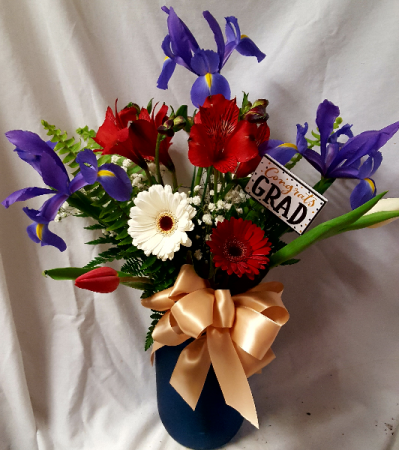 Talawanda Graduation colors! Red, white and blue  flowers arranged in a blue or red mason jar. (The blue flowers could be a Iris or Delphinium and the red and white flowers could change just depends what's n stock)