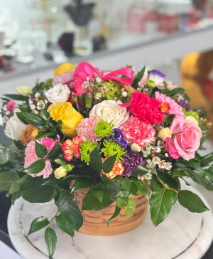 Blooming basket basket arrangement 