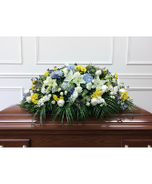 Blue and white with a touch of yellow casket spray 
