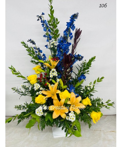 Blue Orange yellow and white sympathy arrangement 