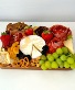 box of cheeses, fruits and sausages 