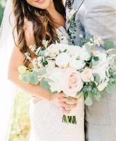 Bridal bouquet  Assortment of roses and baby eucalyptus and silver dollar wrapped with a nice ivory satin ribbon 