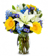 Bright Blue Skies Yellow roses, blue delphinium, white lilies