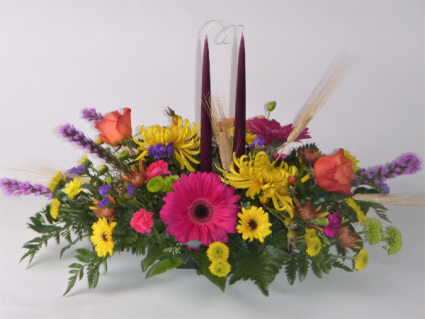 Bright fall centerpiece with tapers Centerpiece