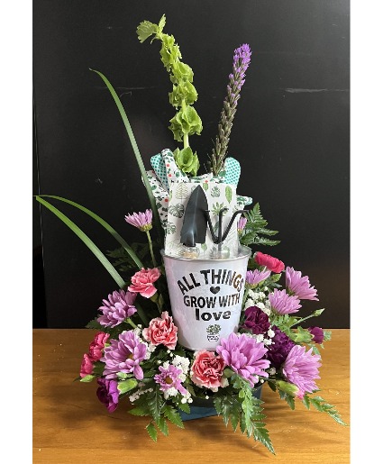 Bucket of gardening tools fresh flowers with keepsake