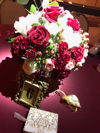 burgundy, blush rose and carnation wedding centerpiece in gold glass vases