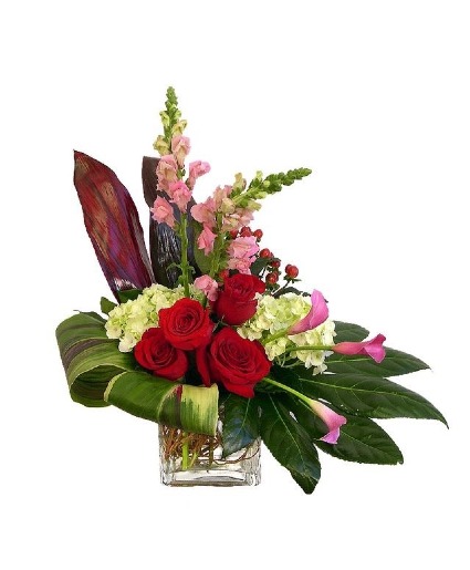 Calla lilly and hydrangea resting on tie leaves arrangement