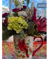 Cardinal Christmas Mug filled with florals Christmas Arrangement