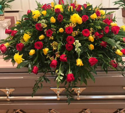 casket blanket  this is a double saddle blanket with red roses, yellow roses , yellow cushions , white stock 