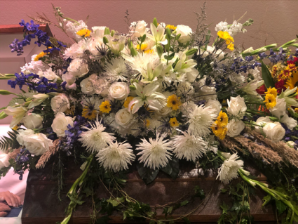Casket flowers with hint of yellow 