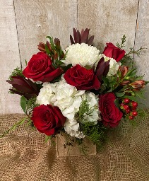 Christmas Cheer Arrangement in glass vase with burlap covering
