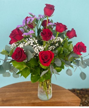 Classic Dozen 12 Red Roses arranged with designer’s choice of filler for a pop of color.