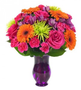 "COLOR EXPLOSION"...Bright flowers in pinks,   orange, purples and lime greens arranged in a vase. (may be clear or a different color vase)