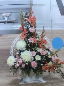 Coral glads, pink carnations, white mums Funeral Basket