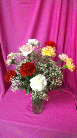 CA12V Crazy in Love Dozen Carnations with baby breath in clear cylinder vase
