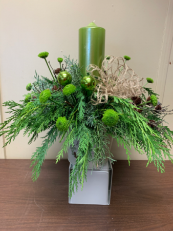 Deck The Halls Centerpiece with large pillar candle and fresh greens