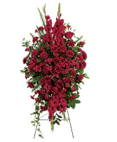 Deep In Our Hearts Standing Spray Red Roses, red carnations, bells of ireland