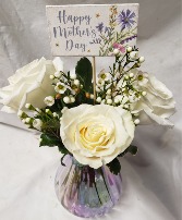 DELIGHTFULLY MOM...3 white roses in a iridescent  Vase with seasonal filler and price INCLUDES Mother's Day pick!