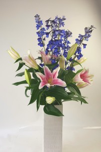 Delphinium Tall and luxurious Style Fragrant lilies and delphinium in a 12 in vase.