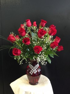 2 Dozen long stem red roses arranged in red vase 