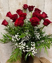 Dozen Red roses  in elegant dark glass vase