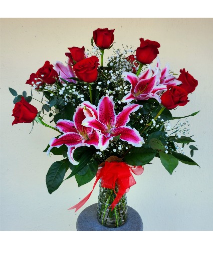 Dozen red roses with stargazer lilies  Arrangement 