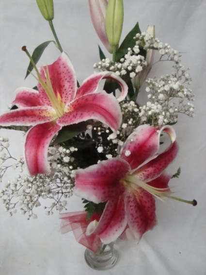 Something as simple as stargazers arranged in a vase with baby's breath. Smells Great!!