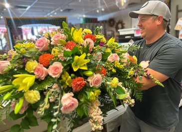 ELEGANT BRIGHT COLORED CASKET SPRAY  in Delphos, OH | Ivy Hutch Flowers and Gifts