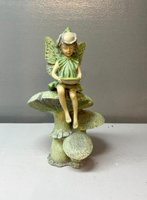 Fairy sitting on mushrooms statue
