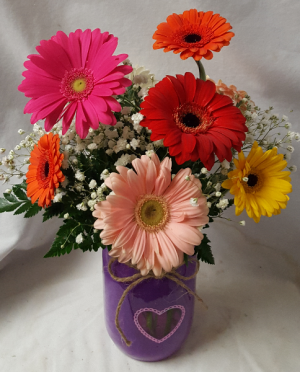DAISY DELIGHT...Colorful Gerbera Daisies arranged  In a Heart Mason Jar! Mason Jar color may vary