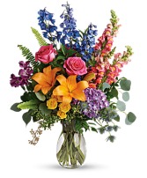 Floral Tribute Vibrant florals arranged beautifully in vase.