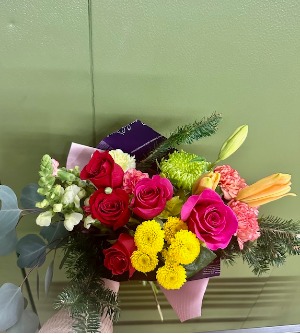 florist choice  wrapped in paper with a bow