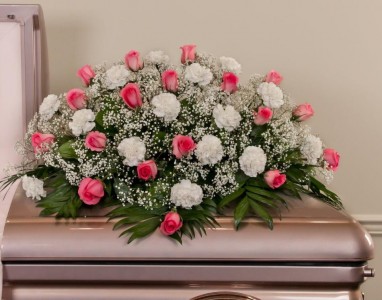 FOREVER IN OUR HEARTS Half Casket Spray of pink Roses and white carnations and baby's breath. ( any color roses and carnations can be substituted if available)