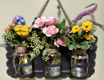 Garden Love Antiqued metal wall hanging with mixed garden flowers. Includes stand for display